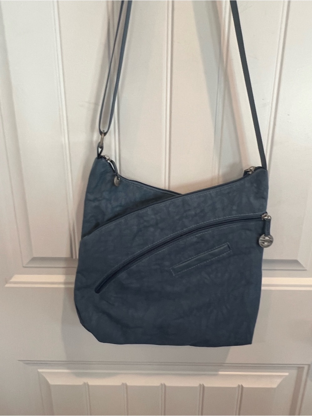 Travelon Slate Blue Crossbody Bag w/Curved Zipper Detail and nylon floral lining